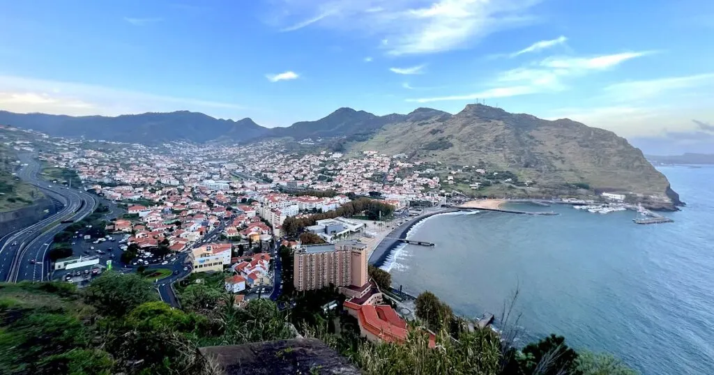View over the traditional Madeiran town of Machico on the east coast, surrounded by hills.