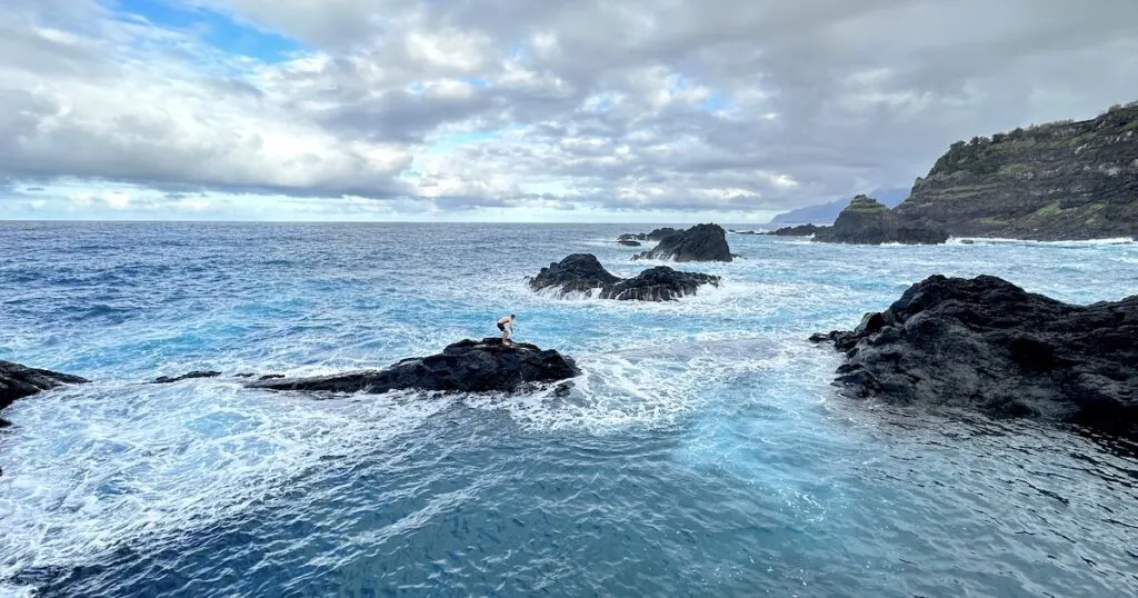 A man balances on the edge of the natural pools in Seixal.