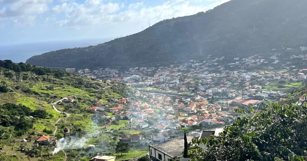 A plume of smoke rises from a farm on the outskirts of Machico in Madeira.