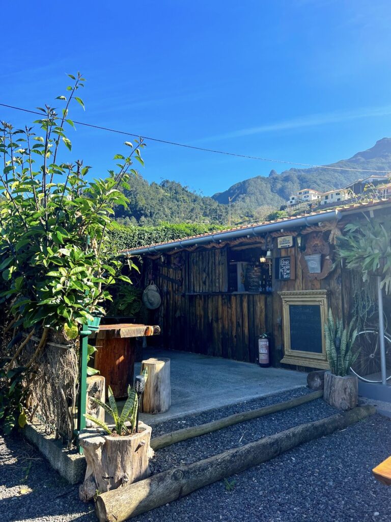 Wooden bar at Granny's Farm Madeira, with hills in the background.