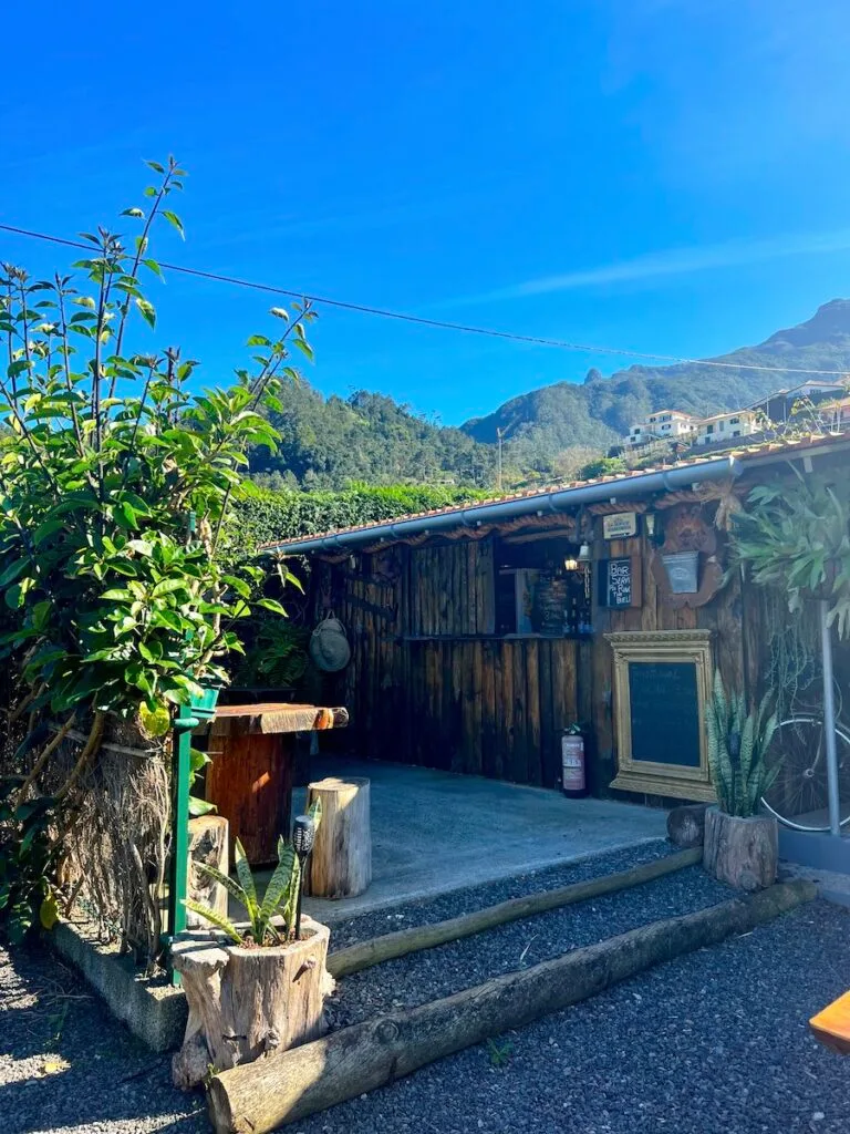 Wooden bar at Granny's Farm Madeira, with hills in the background.