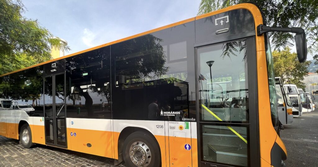 A modern, yellow bus for Curral das Freiras waits at the Funchal bus station.