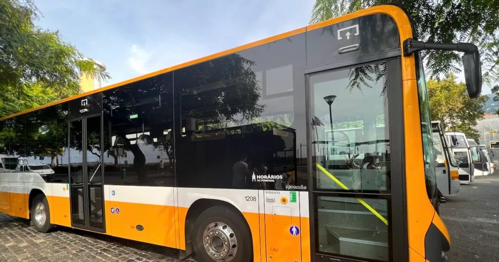 A modern, yellow bus for Curral das Freiras waits at the Funchal bus station.