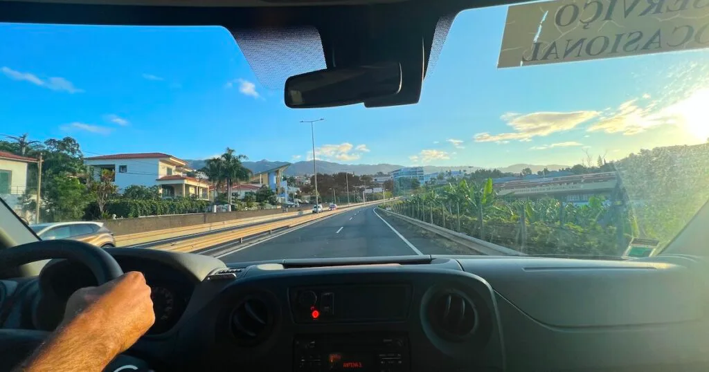 View out of a tour minivan along a main road in Madeira.