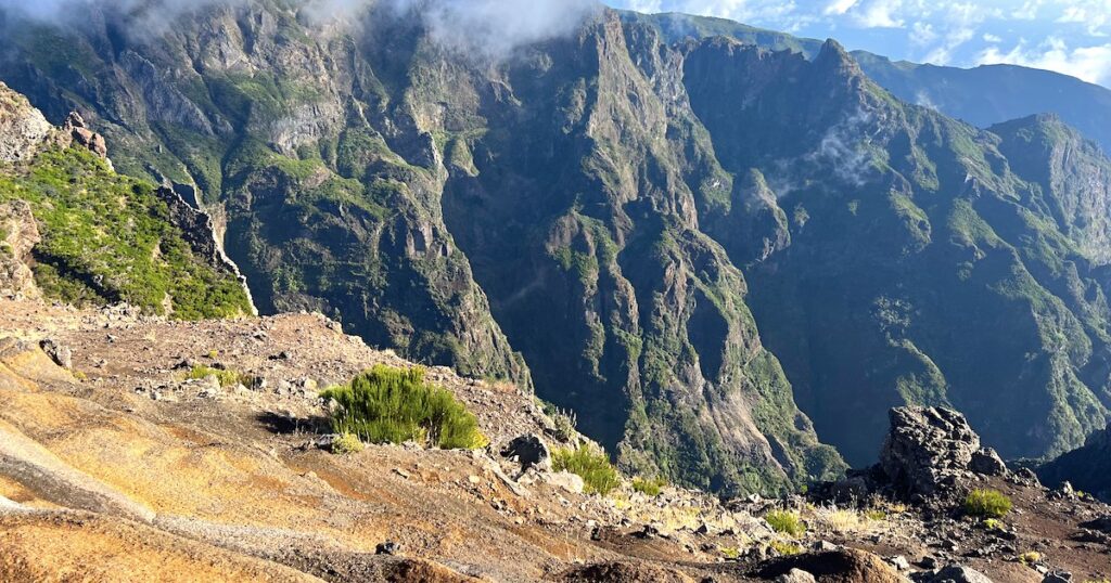 Chiselled, green mountains visible from the PR1 hike in Madeira.