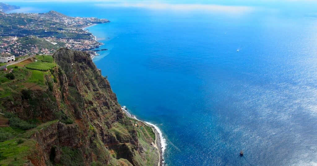 View from Cabo Girão cliff over Madeira’s coastline and the Atlantic Ocean far below.