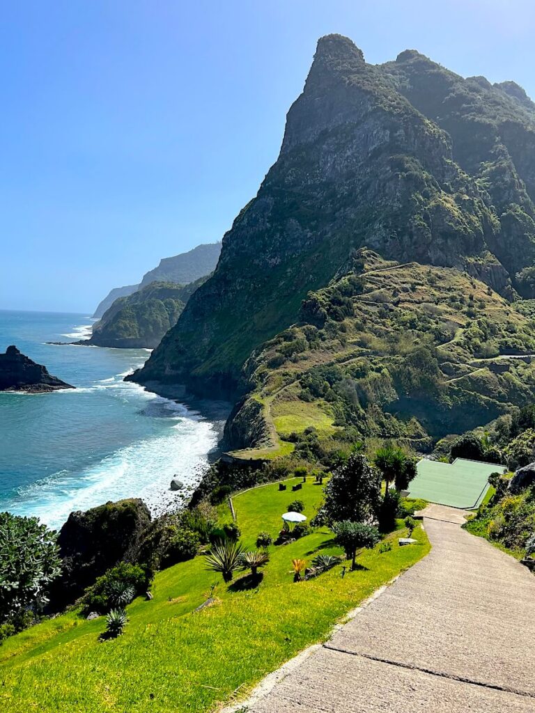 Views of the São Cristóvão Viewpoint, showing steep green cliffs, terraced hillsides and the Atlantic coastline of Madeira.