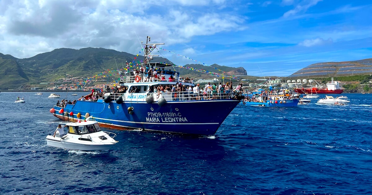 Boats packed with festival-goers taking part in the Festa de Nossa Senhora da Piedade procession off Caniçal.